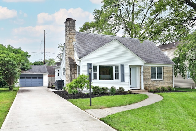 2009 Zollinger Rd, Columbus, OH 43221 - view of front of home with central air condition unit, an outbuilding, a shingled roof, stone siding, and a chimney