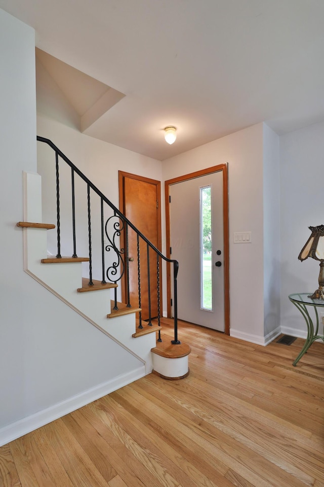 2009 Zollinger Rd, Columbus, OH 43221 - foyer entrance featuring baseboards, light wood-type flooring, and stairway