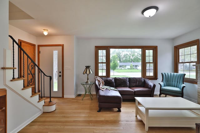 2009 Zollinger Rd, Columbus, OH 43221 - living area featuring light wood-style flooring, stairway, and baseboards