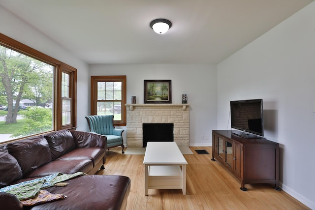 2009 Zollinger Rd, Columbus, OH 43221 - living area with light wood-style flooring, a fireplace, and baseboards