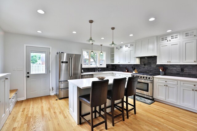 2009 Zollinger Rd, Columbus, OH 43221 - kitchen with stainless steel appliances, plenty of natural light, decorative backsplash, glass insert cabinets, and recessed lighting