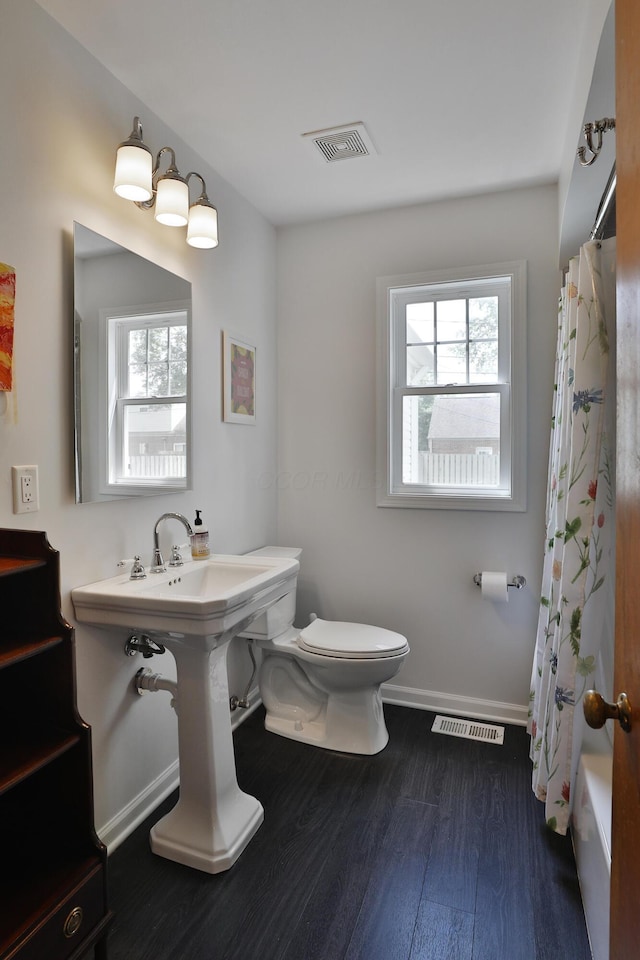 2009 Zollinger Rd, Columbus, OH 43221 - full bath with toilet, wood finished floors, baseboards, and shower / tub combo