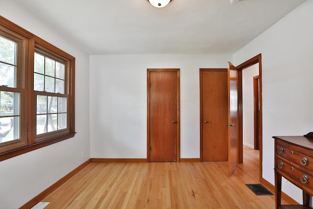 2009 Zollinger Rd, Columbus, OH 43221 - unfurnished bedroom featuring light wood-style floors and baseboards