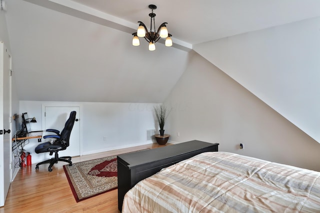 2009 Zollinger Rd, Columbus, OH 43221 - bedroom featuring light wood finished floors, a chandelier, vaulted ceiling, and an office area