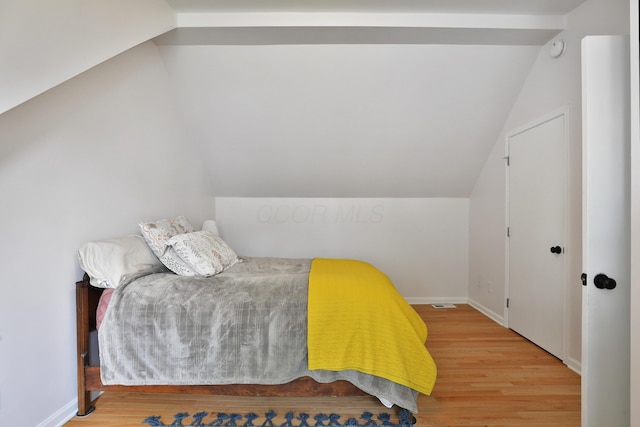 2009 Zollinger Rd, Columbus, OH 43221 - bedroom with lofted ceiling, wood finished floors, and baseboards