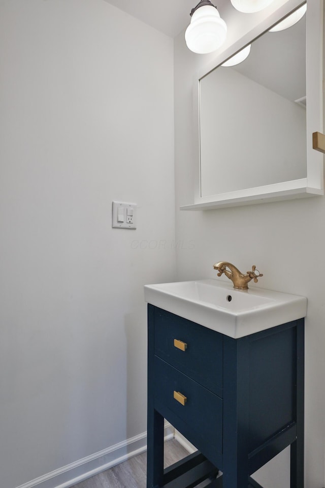 2009 Zollinger Rd, Columbus, OH 43221 - bathroom featuring vanity, baseboards, and wood finished floors
