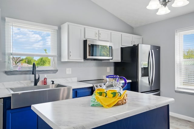 1627 Metcalfe Ave, Columbus, OH 43207 - kitchen featuring stainless steel appliances, a sink, vaulted ceiling, light countertops, and plenty of natural light