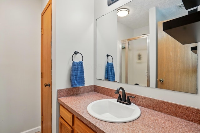 1627 Metcalfe Ave, Columbus, OH 43207 - bathroom featuring a stall shower, vanity, and a textured ceiling