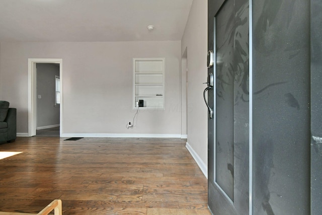 2567 Joyce Ave, Columbus, OH 43211 - empty room featuring built in features, wood finished floors, baseboards, and a smoke detector