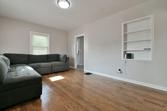 2567 Joyce Ave, Columbus, OH 43211 - living area featuring baseboards, wood finished floors, and built in shelves