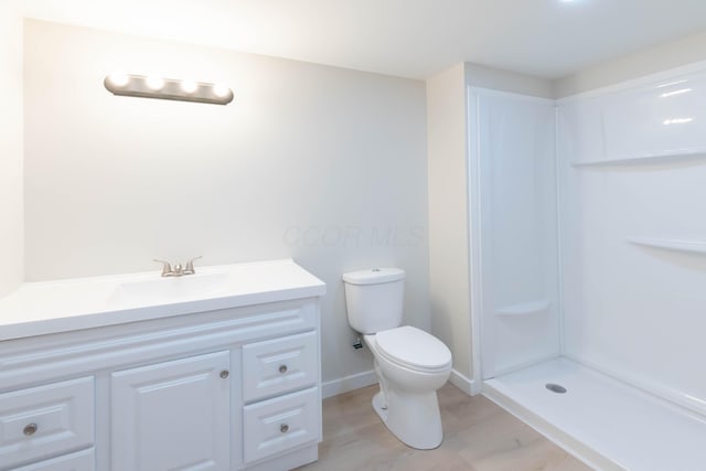 109 E Home Rd, Springfield, OH 45504 - bathroom featuring toilet, vanity, wood finished floors, a shower, and baseboards