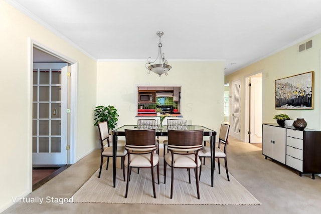 1631 Roxbury Rd Unit D2, Columbus, OH 43212 - dining room featuring carpet floors and ornamental molding
