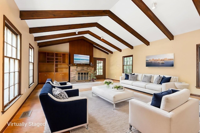 1631 Roxbury Rd Unit D2, Columbus, OH 43212 - living room with a glass covered fireplace, beamed ceiling, wood finished floors, and high vaulted ceiling