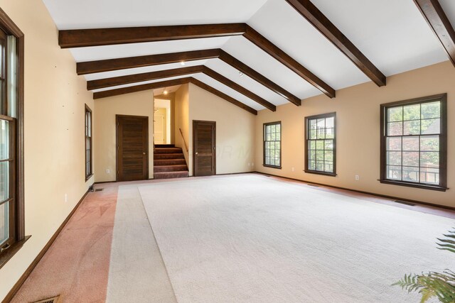 1631 Roxbury Rd Unit D2, Columbus, OH 43212 - unfurnished living room with light colored carpet, healthy amount of natural light, beam ceiling, stairs, and high vaulted ceiling