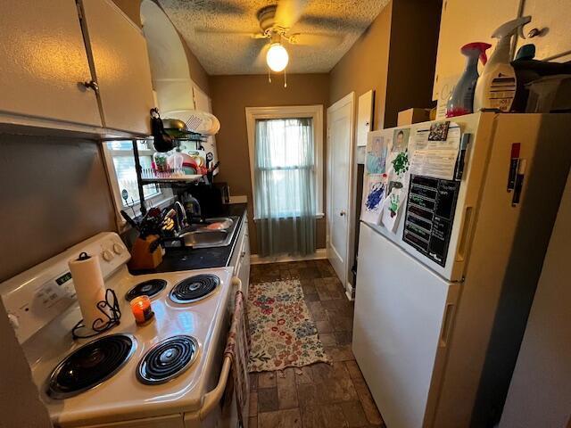 1231 E 23rd Ave, Columbus, OH 43211 - kitchen featuring white appliances, a sink, ceiling fan, and a textured ceiling