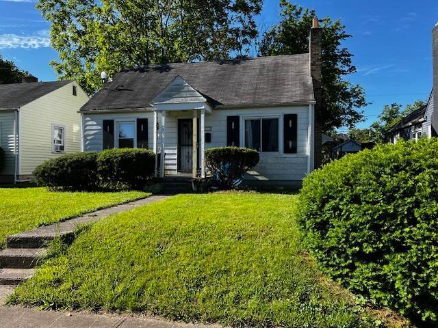 1231 E 23rd Ave, Columbus, OH 43211 - view of front facade with a front yard and a chimney