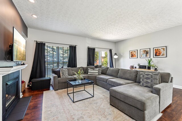4006 Darby Park Rd, Hilliard, OH 43026 - living room featuring a textured ceiling, wood finished floors, recessed lighting, and a tiled fireplace
