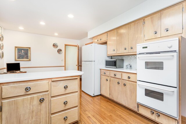 2772 Dale Ave, Columbus, OH 43209 - kitchen featuring white appliances, light wood-style floors, light countertops, light brown cabinetry, and decorative backsplash