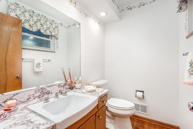 2772 Dale Ave, Columbus, OH 43209 - half bath with vanity, wood finished floors, and toilet