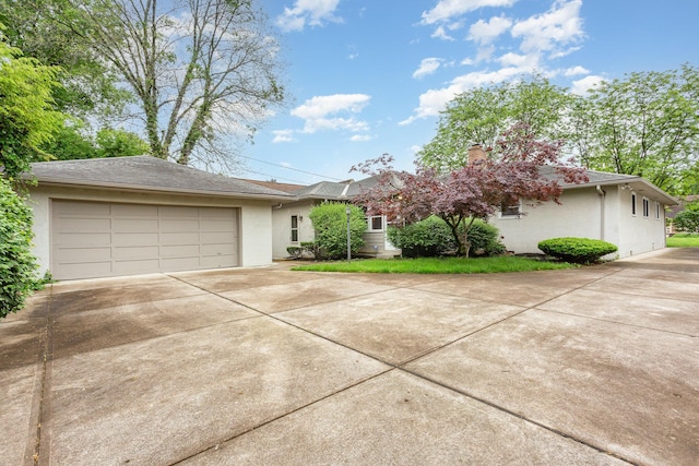 2772 Dale Ave, Columbus, OH 43209 - view of front of house with concrete driveway, stucco siding, a garage, and a chimney