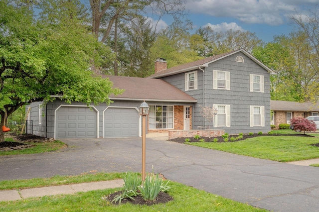 837 Cherry Bottom Rd, Columbus, OH 43230 - view of front of home with asphalt driveway, a chimney, an attached garage, and a front lawn