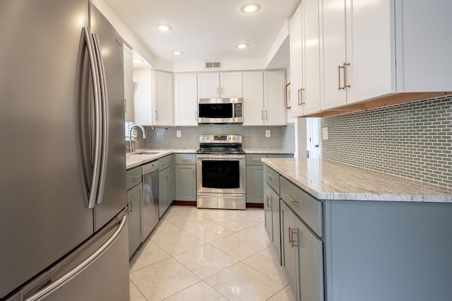 837 Cherry Bottom Rd, Columbus, OH 43230 - kitchen with appliances with stainless steel finishes, a sink, gray cabinetry, decorative backsplash, and recessed lighting
