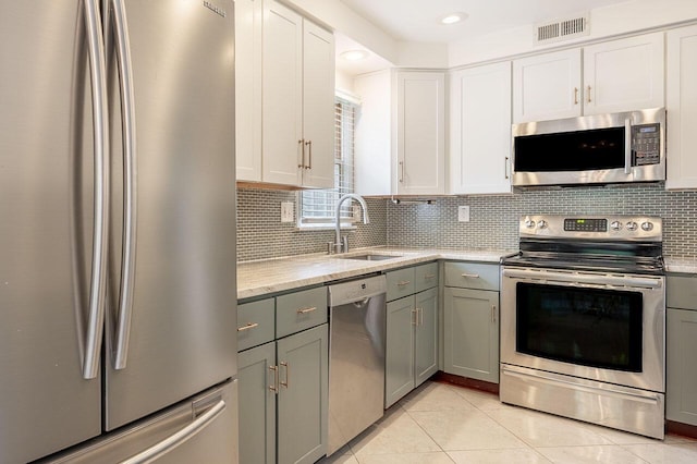 837 Cherry Bottom Rd, Columbus, OH 43230 - kitchen featuring stainless steel appliances, a sink, gray cabinetry, backsplash, and light tile patterned flooring