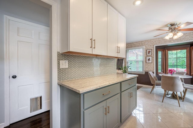 837 Cherry Bottom Rd, Columbus, OH 43230 - kitchen featuring gray cabinets, baseboards, a ceiling fan, backsplash, and white cabinets