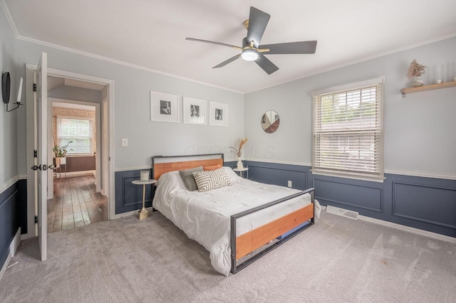 837 Cherry Bottom Rd, Columbus, OH 43230 - carpeted bedroom with crown molding, a wainscoted wall, and a ceiling fan