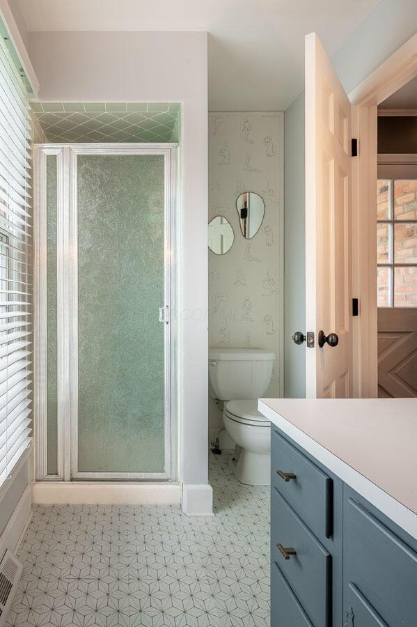 837 Cherry Bottom Rd, Columbus, OH 43230 - full bath with vanity, a stall shower, toilet, and tile patterned floors