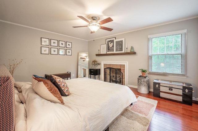 837 Cherry Bottom Rd, Columbus, OH 43230 - bedroom featuring wood finished floors, ornamental molding, a fireplace, a ceiling fan, and baseboards