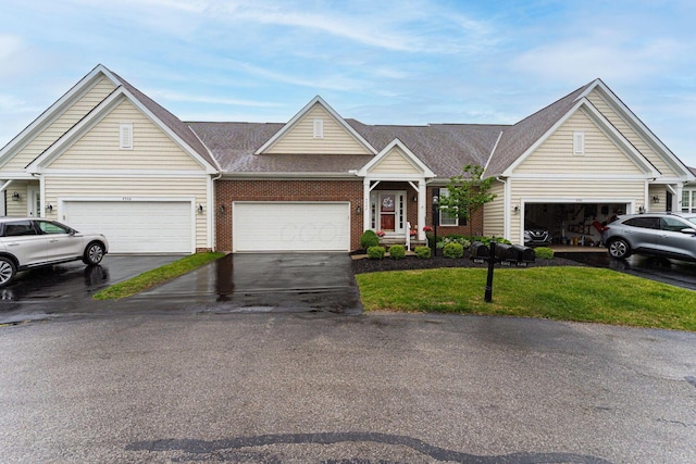 4502 Bens Ct Unit 31, Hilliard, OH 43026 - view of front facade with a front lawn, asphalt driveway, brick siding, an attached garage, and roof with shingles