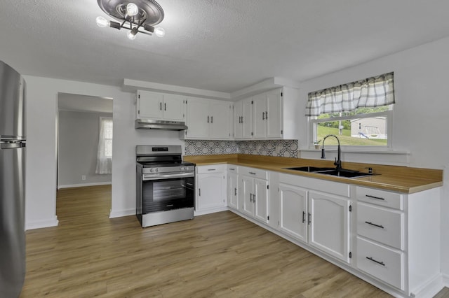 19616 N St, Laurelville, OH 43135 - kitchen featuring appliances with stainless steel finishes, under cabinet range hood, a sink, white cabinetry, and a textured ceiling