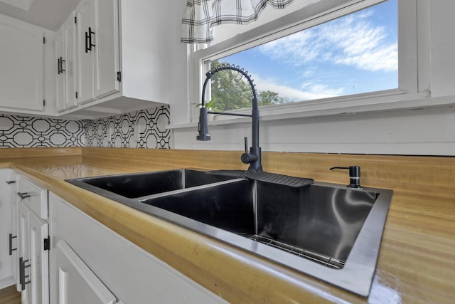 19616 N St, Laurelville, OH 43135 - kitchen view of a sink, white cabinetry, backsplash, and wood counters