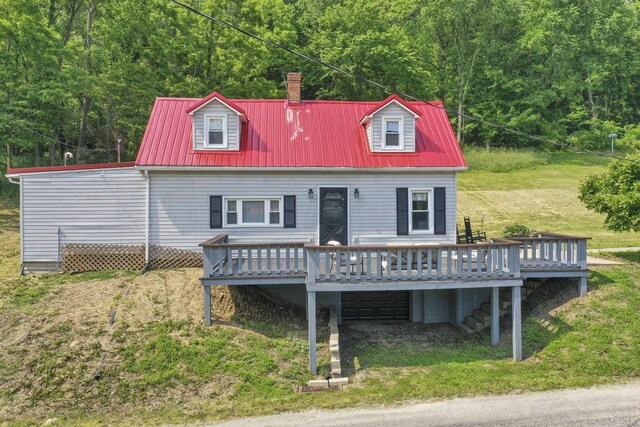 19616 N St, Laurelville, OH 43135 - back of property featuring a wooden deck, metal roof, a forest view, and an attached garage
