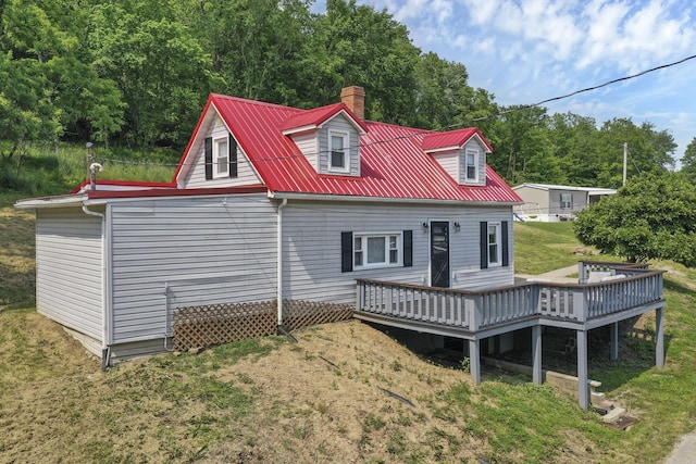 19616 N St, Laurelville, OH 43135 - rear view of house featuring a deck, a chimney, metal roof, and a lawn
