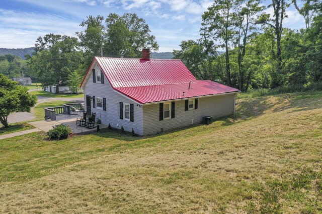 19616 N St, Laurelville, OH 43135 - view of home's exterior with a chimney, cooling unit, a yard, metal roof, and a patio