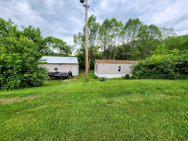 6960 Bluebell Rd, Cumberland, OH 43732 - view of green lawn with an outdoor structure
