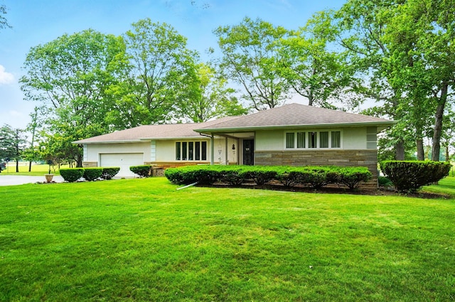 8430 Patterson Rd, Hilliard, OH 43026 - view of front of house with a front yard, an attached garage, and stone siding