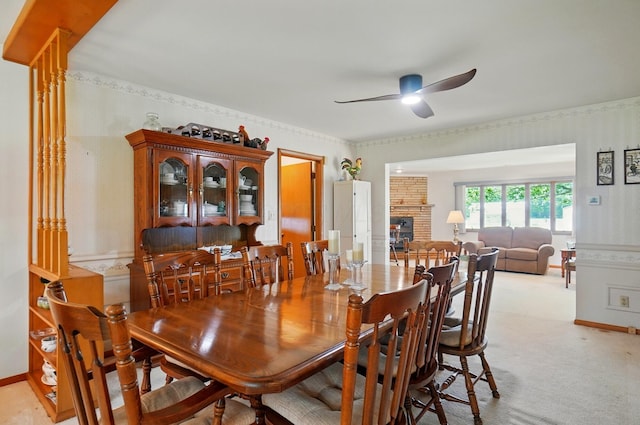 8430 Patterson Rd, Hilliard, OH 43026 - dining room featuring ceiling fan, wallpapered walls, light carpet, a brick fireplace, and baseboards