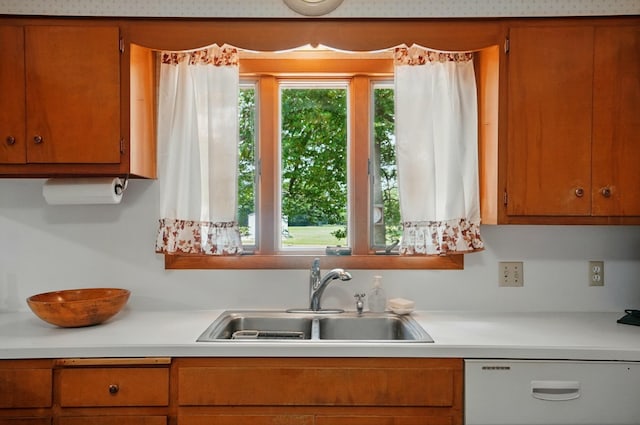 8430 Patterson Rd, Hilliard, OH 43026 - kitchen featuring white dishwasher, a sink, light countertops, and brown cabinetry