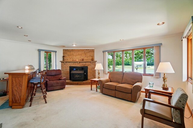 8430 Patterson Rd, Hilliard, OH 43026 - living room with healthy amount of natural light, light carpet, ornamental molding, a stone fireplace, and recessed lighting