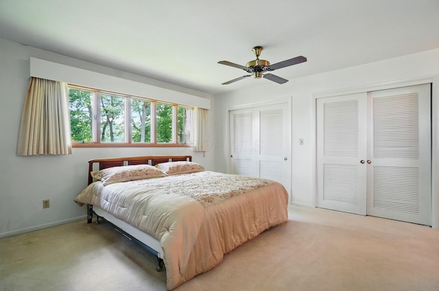 8430 Patterson Rd, Hilliard, OH 43026 - bedroom featuring multiple closets, light carpet, baseboards, and a ceiling fan