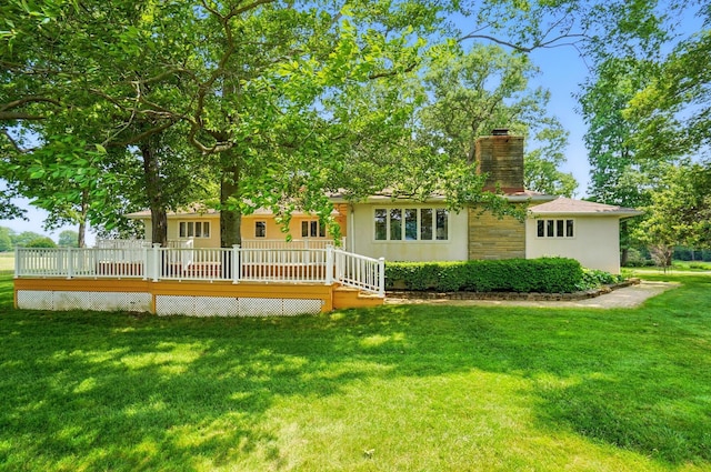 8430 Patterson Rd, Hilliard, OH 43026 - back of house with a chimney, stucco siding, a yard, and a wooden deck