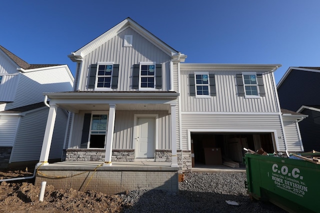 6865 Losino Ln, Hilliard, OH 43026 - view of front facade featuring covered porch, board and batten siding, and a garage