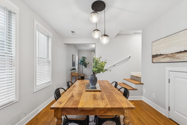 159 E 4th Ave, Columbus, OH 43201 - dining space featuring wood finished floors, baseboards, and stairs