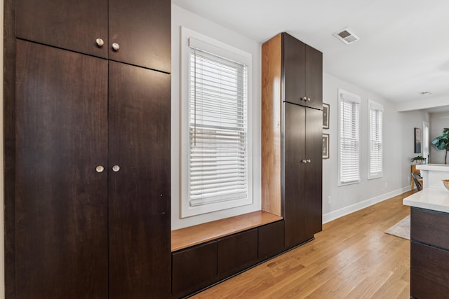 159 E 4th Ave, Columbus, OH 43201 - interior space with baseboards, light wood-style floors, dark brown cabinets, and light countertops