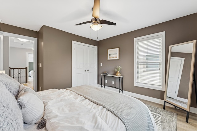 159 E 4th Ave, Columbus, OH 43201 - bedroom with light wood finished floors, baseboards, ceiling fan, and a closet