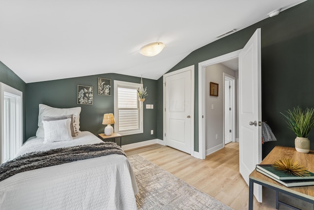 159 E 4th Ave, Columbus, OH 43201 - bedroom featuring wood finished floors, lofted ceiling, and baseboards