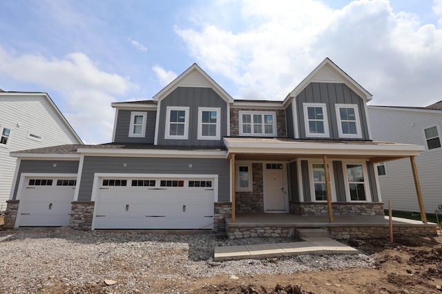 6946 Stillhouse Ln, Dublin, OH 43016 - craftsman-style house featuring covered porch, board and batten siding, stone siding, and driveway